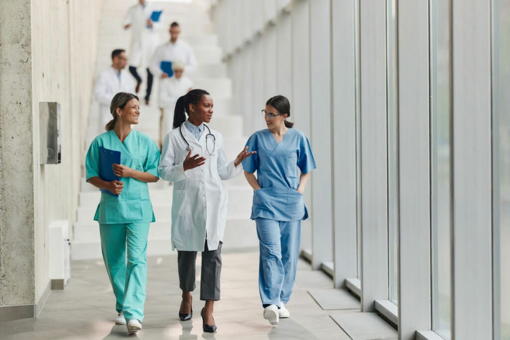 HEalthcare workers interacting as they walk