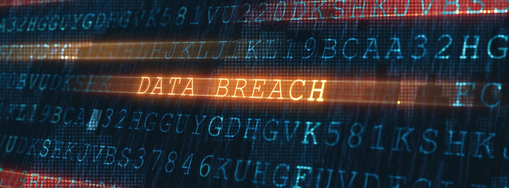 Monitor with numbers and letters plus data breach typed across the screen
